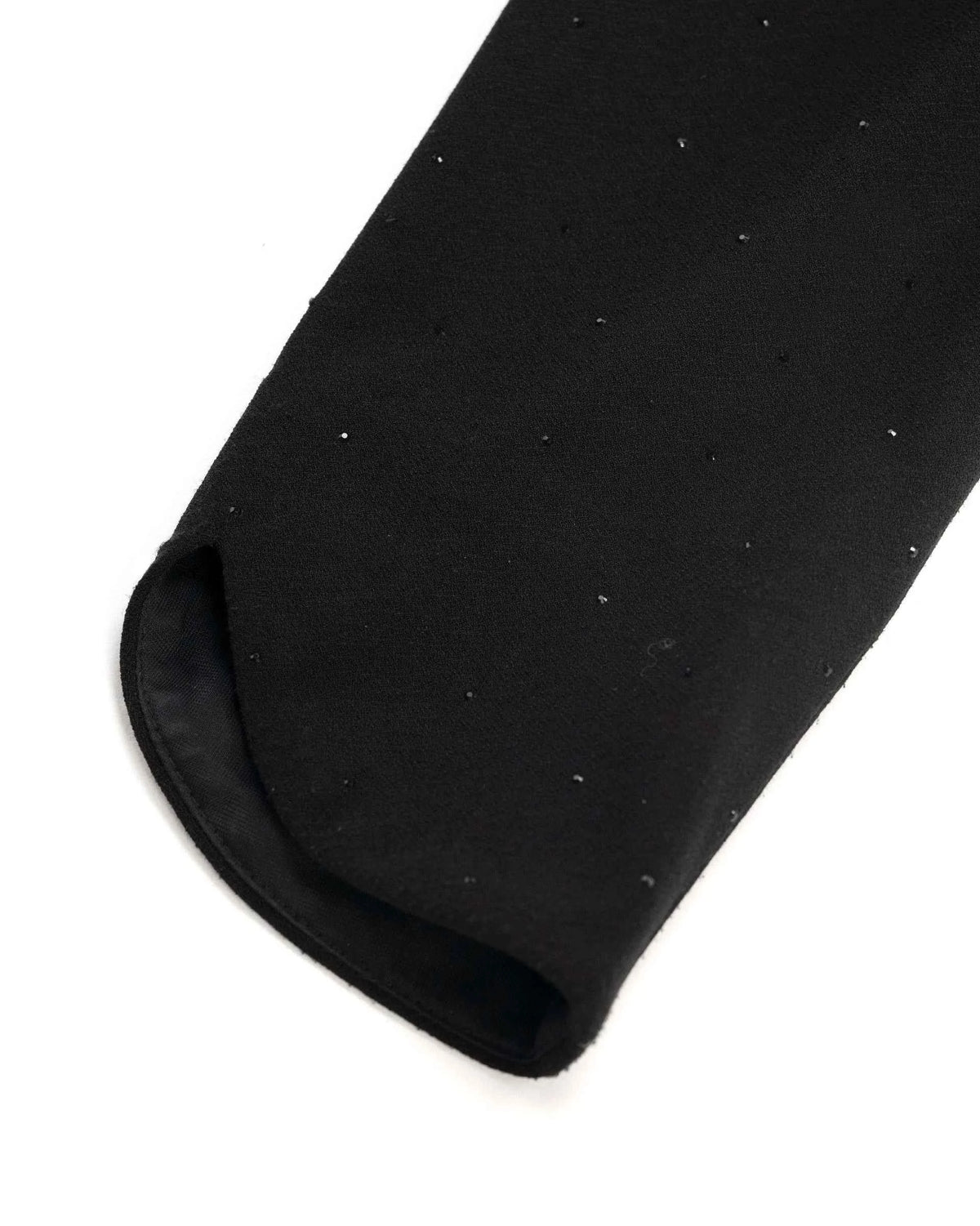 The sleeve ends in a gently curved edge, with a darker inner surface visible close up.