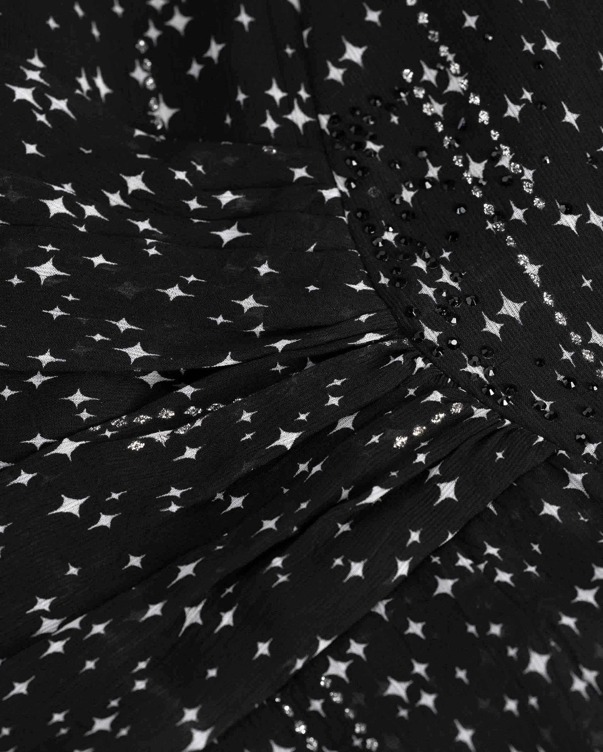 Close folds gather towards the side of the waist, changing direction across the fabric.