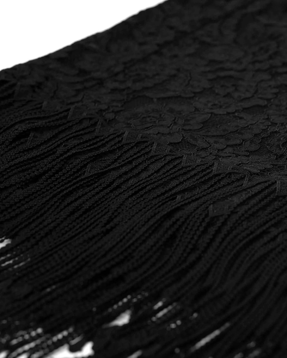 Long dark fringe falls below the floral lace, creating a loose lower border.
