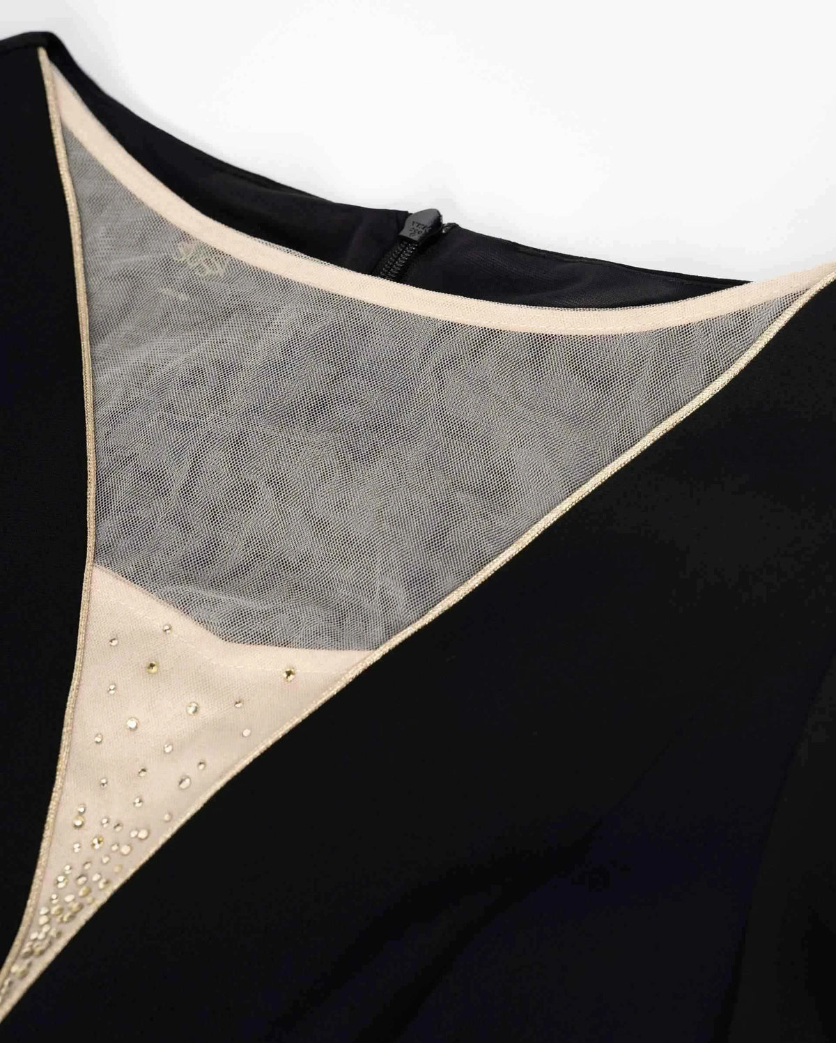 A pale transparent inset sits inside the deep dark neckline, with a fine border defining its shape.
