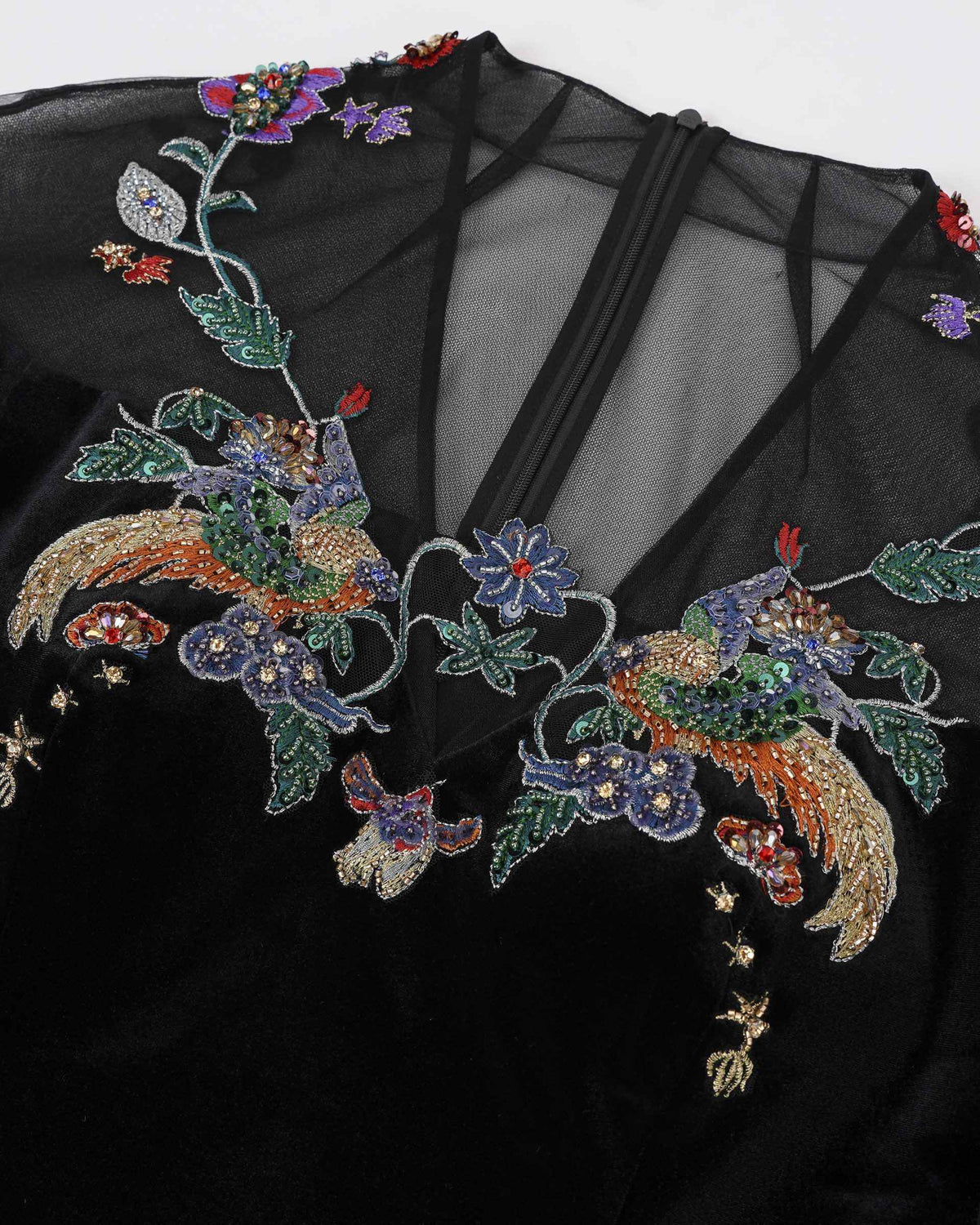 Colourful phoenix and floral motifs sit around the transparent upper panel.