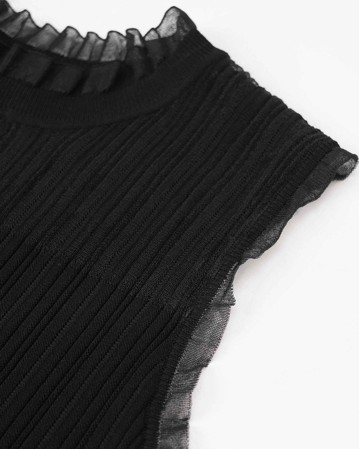 A transparent panel rises above the ribbed body and finishes with a delicate ruffled edge.