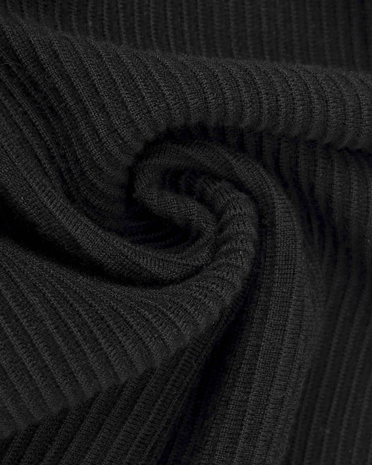Fine ribs run through the folded knit, becoming more pronounced in the light.