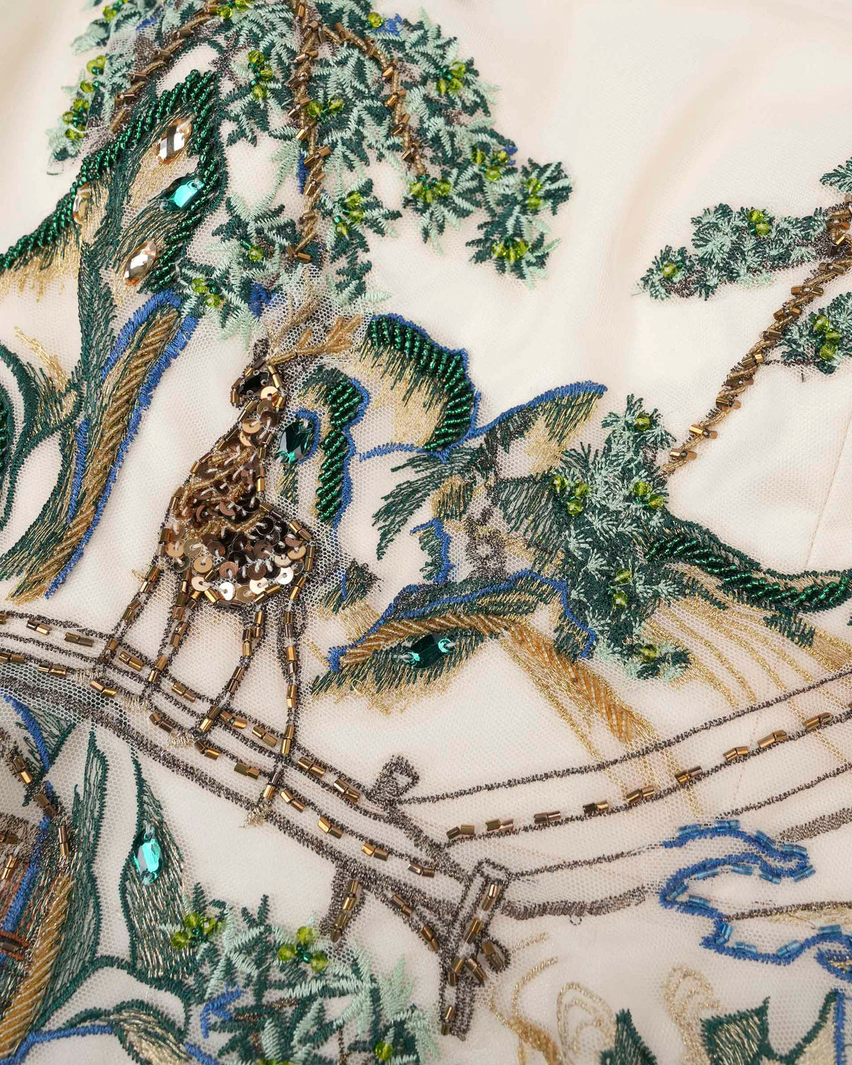 A deer, trees, and rocky forms emerge in green and brown tones against ivory.