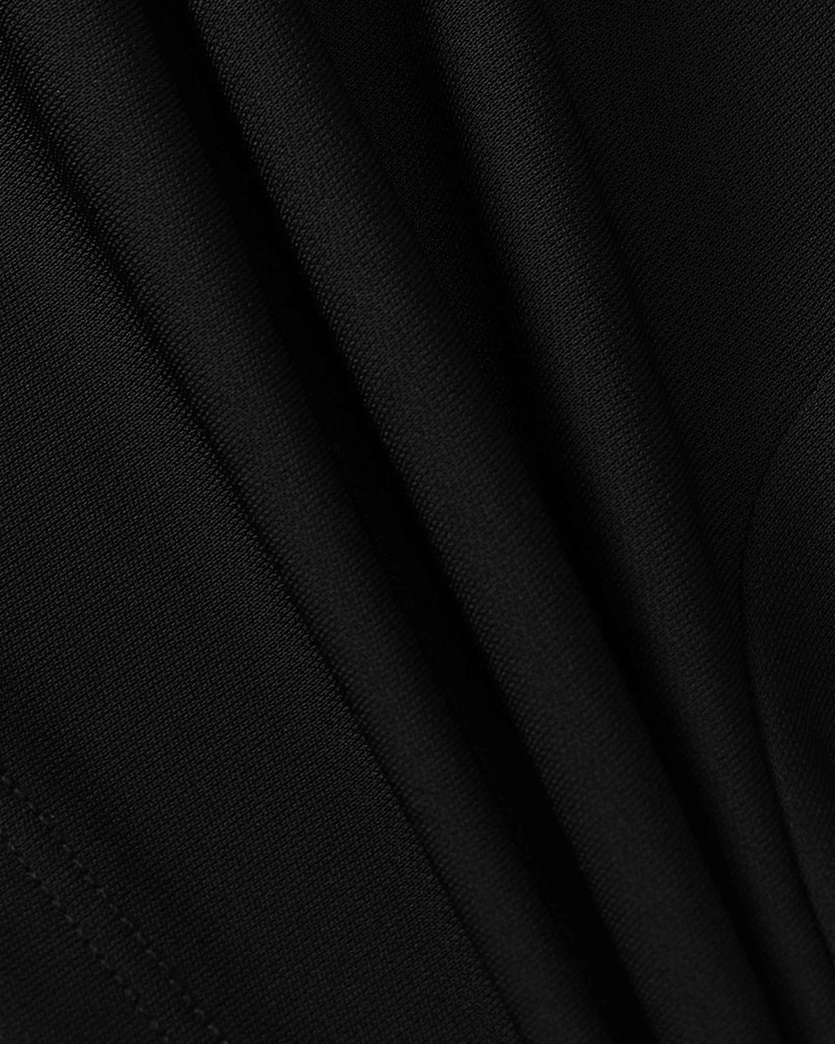 The close view shows soft highlights along the folds of the black fabric.