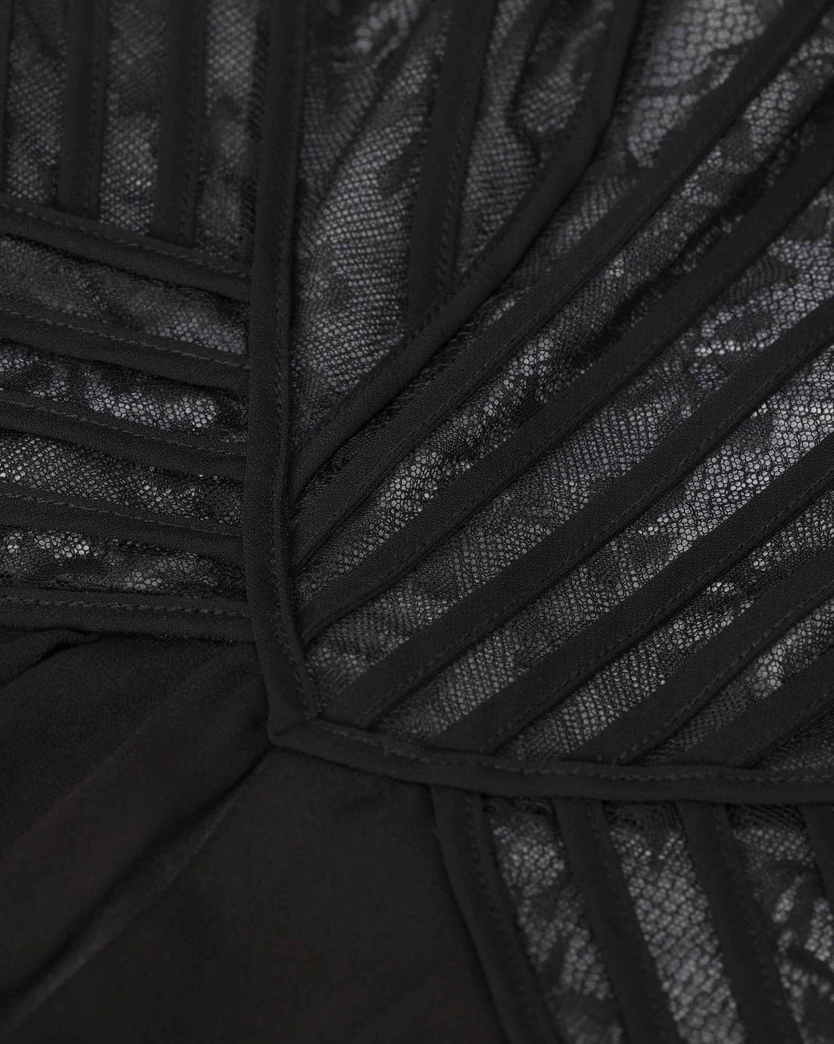 Narrow dark bands radiate across the transparent floral upper section towards the waist.