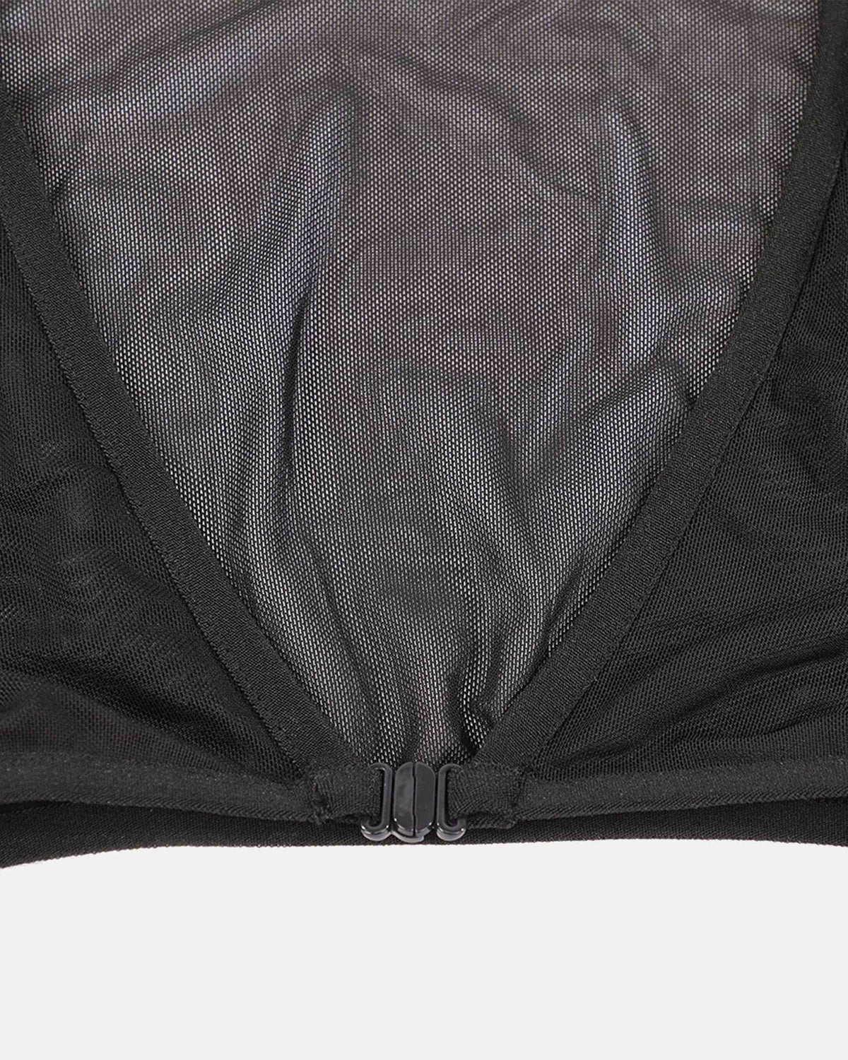 Fine transparent fabric spans the back, with a seam defining its construction.