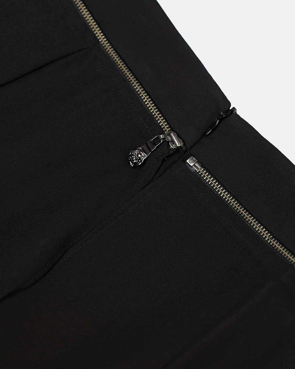 The waistband and fastening form a neat upper finish, with seam lines continuing into the body.