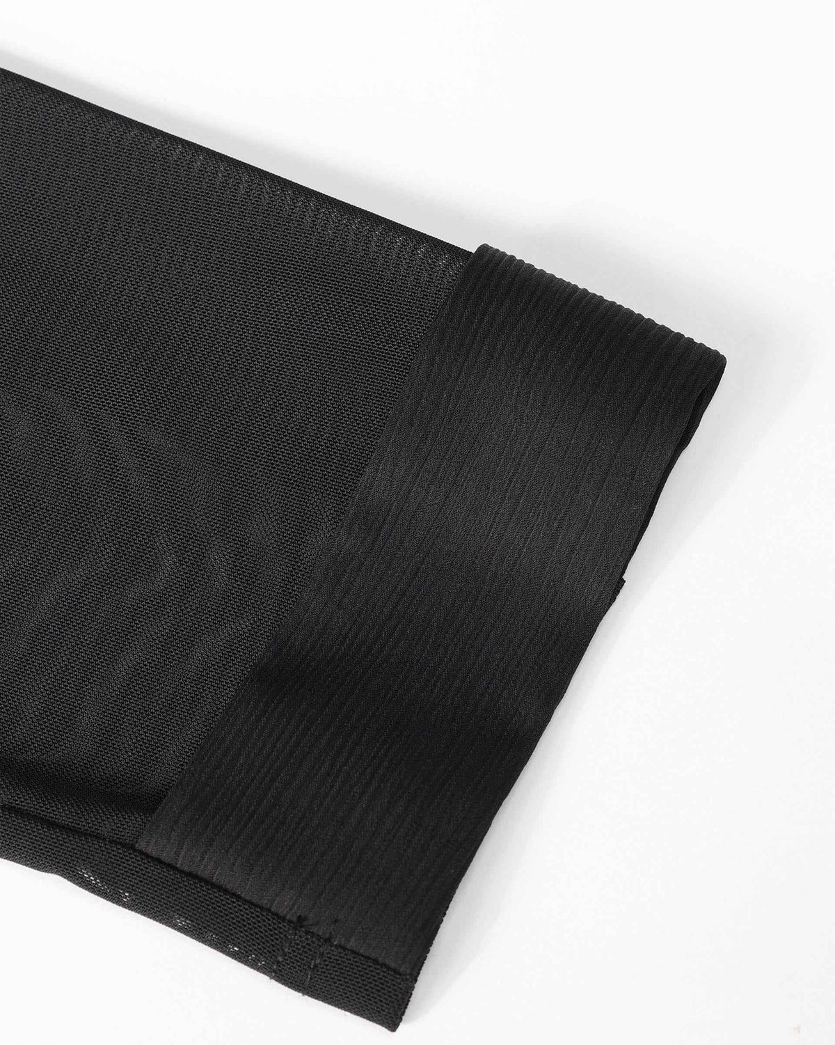 The sleeve ends in a plain, carefully defined cuff, giving the dark fabric a clear lower edge.