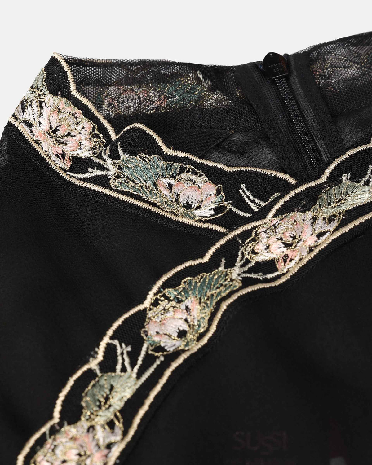 Pale flowers and gold toned outlines follow the collar and diagonal upper edge.