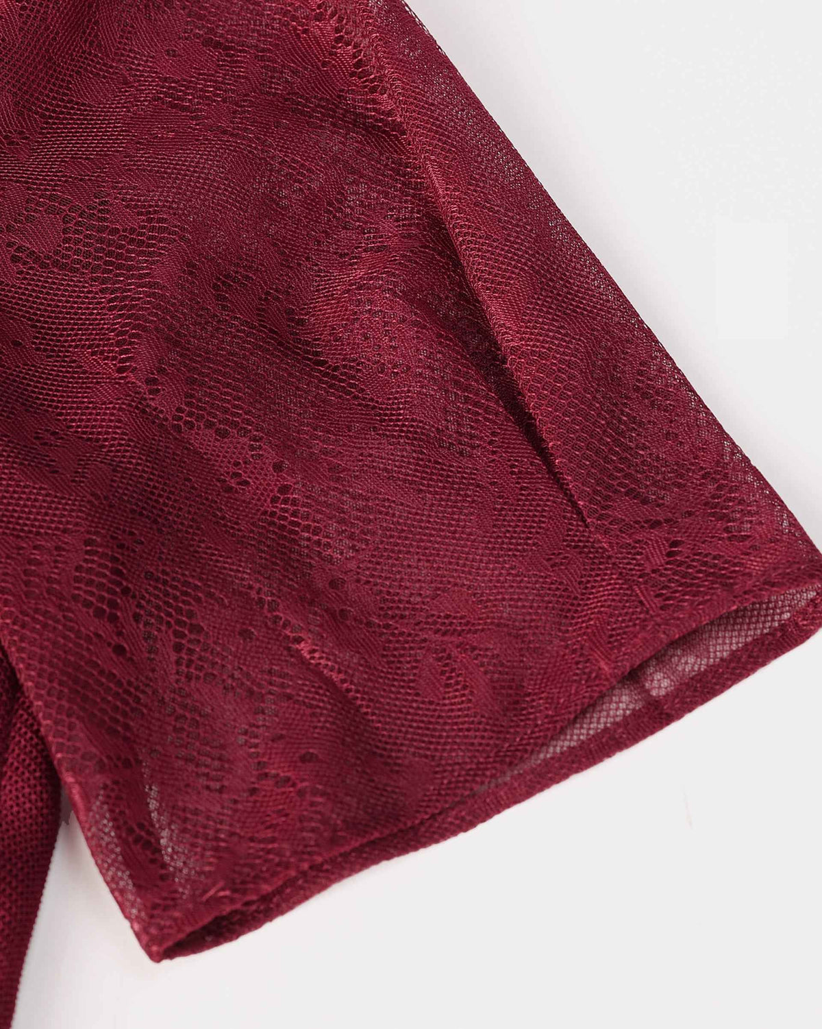 The short sleeve reveals the lace's floral forms and fine open spaces.