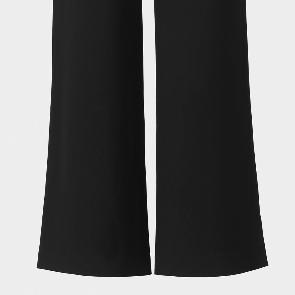 The back legs follow long, straight lines through plain black fabric.