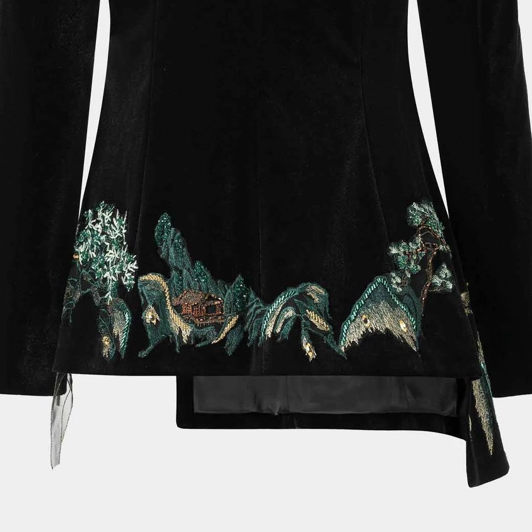 A band of landscape embroidery extends across the lower back, contrasting with the plain dark fabric above.