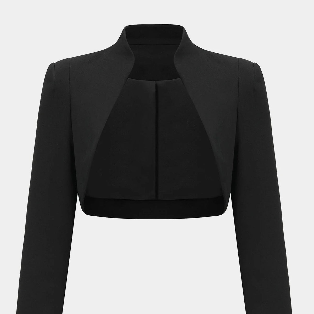 The cropped jacket's open front curves away from the body, leaving the garment beneath visible.