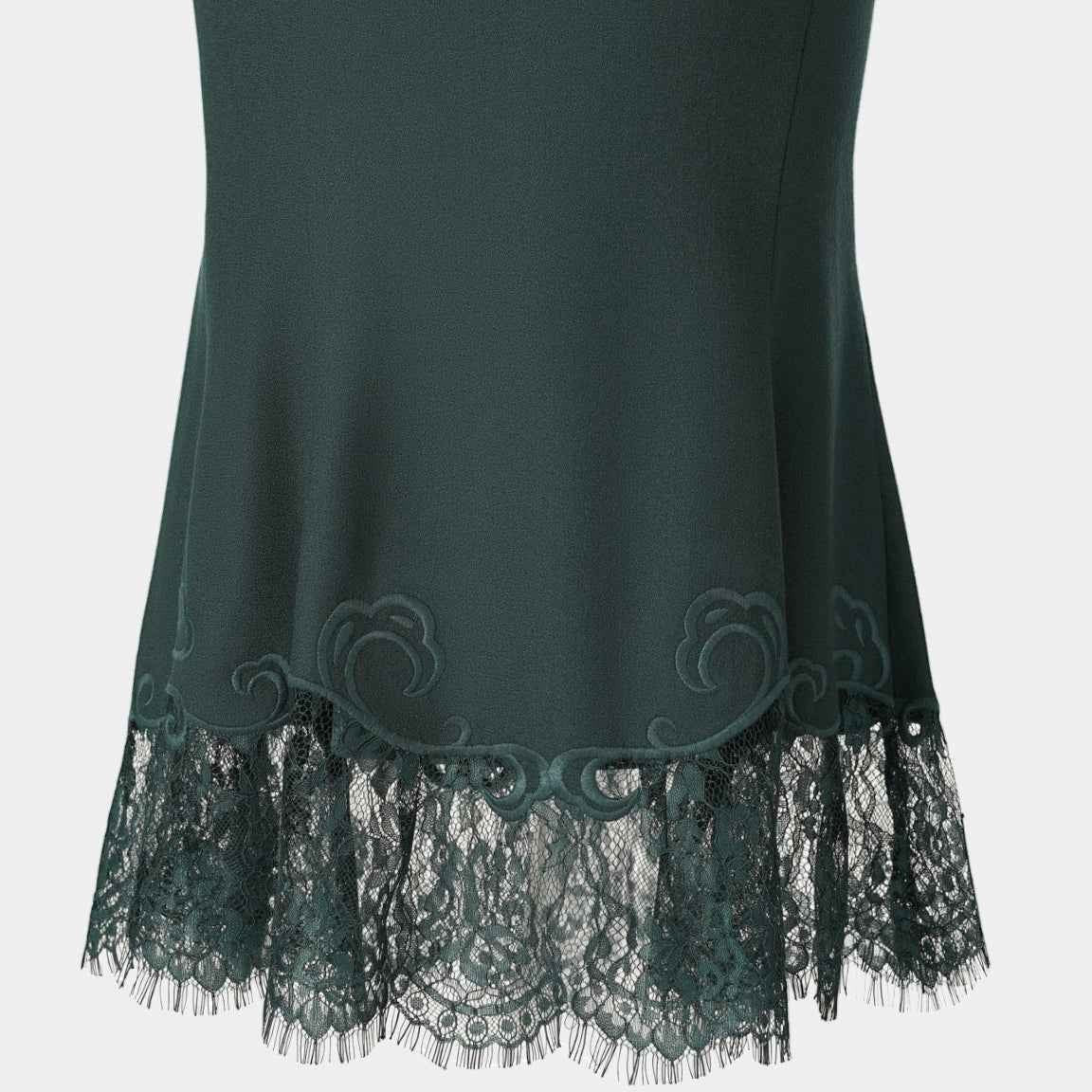 The back view shows the skirt opening into a wider lower shape above the lace border.