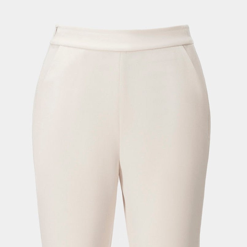 A wide pale waistband sits above the trouser legs, establishing a clean upper frame.