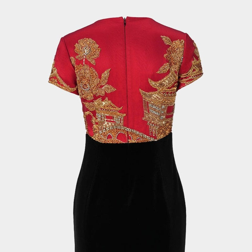 The red back panel carries the decorative theme across the shoulders before meeting the plain black skirt.